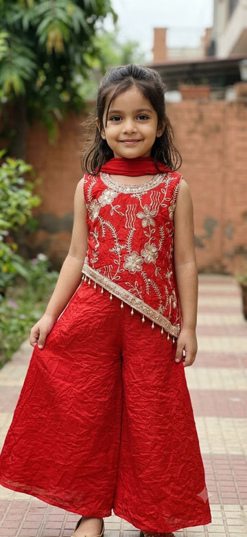 Orangish red slant top with tassels and palazzo