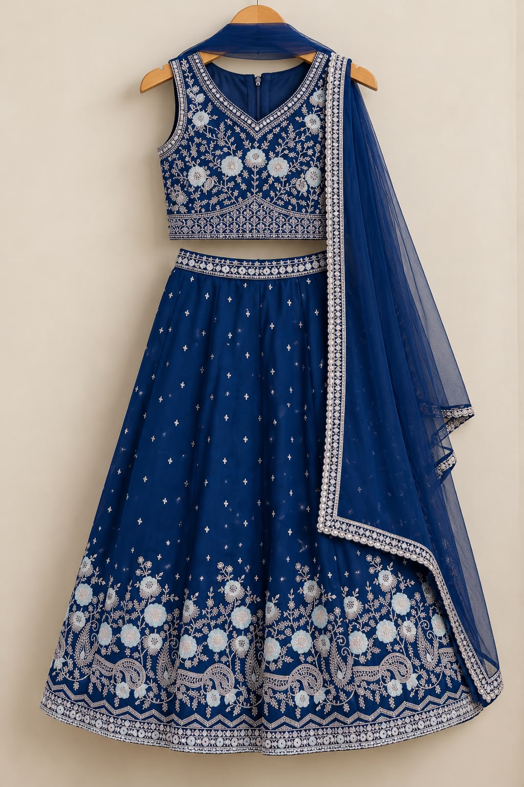 Intense blue embroidered choli, matching lehenga with border work and net dupatta